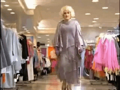 Woman Walking Through Clothing Store