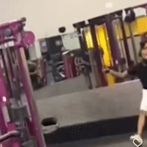 Woman Walking Through Gym With Heart Shoe