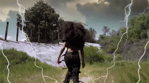 Woman Walking Through Lightning Field