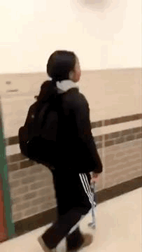 Woman Walking With Backpack and Skateboard