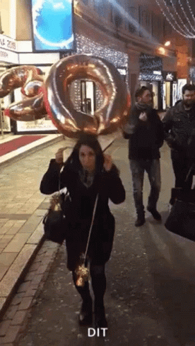 Woman Walking With Balloon Saying Dit