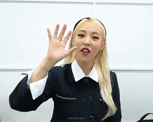 Woman Waving Hand in Headband and Black Jacket