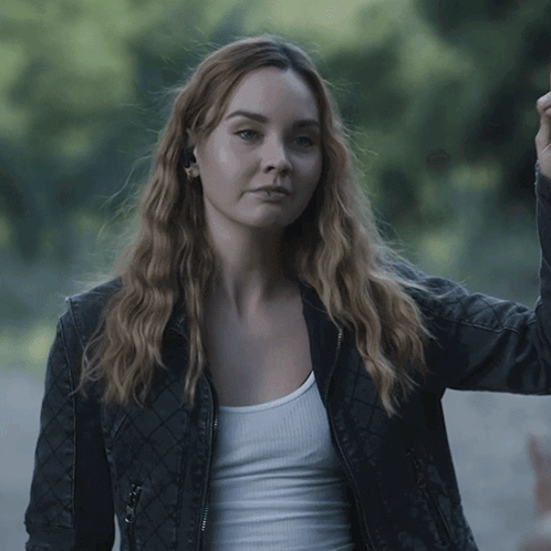 Woman Wearing Black Jacket and White Tank Top Gotcha