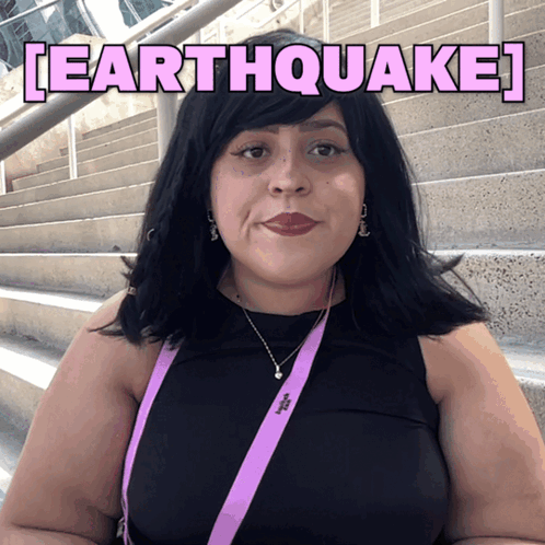 Woman Wearing Black Top And Earthquake Lanyard GIF