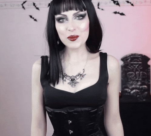 Woman Wearing Black Top and Heart Necklace