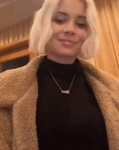 Woman Wearing Black Turtleneck And Love Necklace GIF