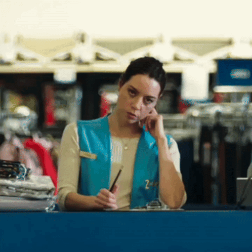 Woman Wearing Blue Vest With Z on Phone