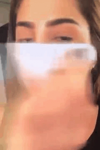 Woman Wearing Face Mask Holding Cell Phone GIF