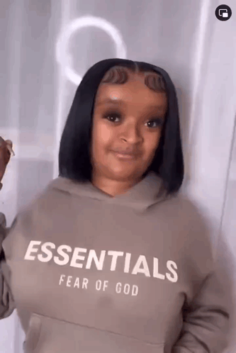 Woman Wearing Fear of God Essentials Hoodie
