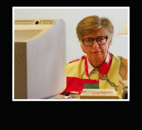 Woman Wearing Glasses and Apron at Computer
