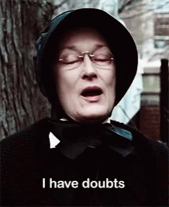 Woman Wearing Glasses and Black Hat Saying I Have Doubts