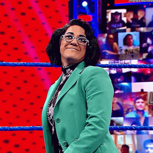 Woman Wearing Glasses and Green Jacket in Wrestling Ring
