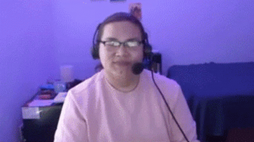 Woman Wearing Glasses and Headset Sitting at Desk