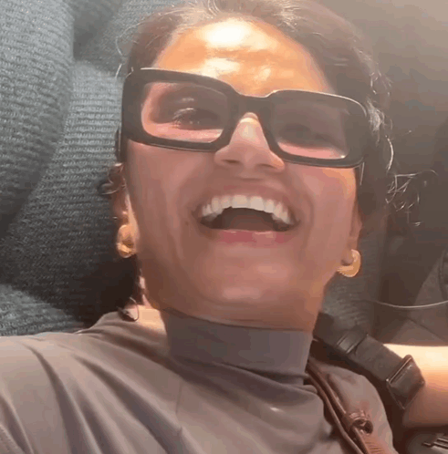 Woman Wearing Glasses and Turtleneck Smiling
