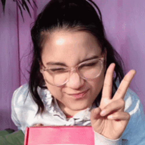 Woman Wearing Glasses Making Peace Sign