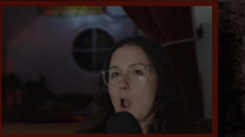 Woman Wearing Glasses Talking Into Microphone GIF