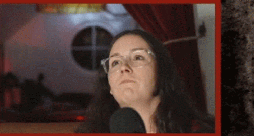 Woman Wearing Glasses Talking Into Microphone GIF
