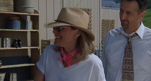 Woman Wearing Hat Next to Man