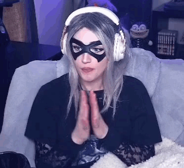 Woman Wearing Headphones and Mask Sitting