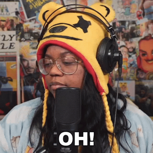 Woman Wearing Headphones And Winnie The Pooh Hat Says Oh GIF