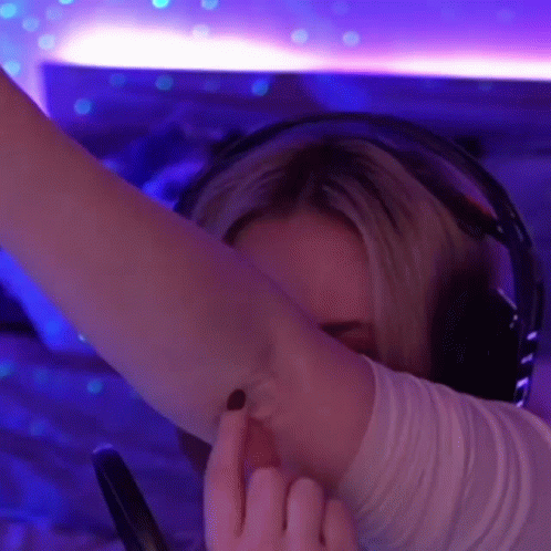 Woman Wearing Headphones Giving Middle Finger