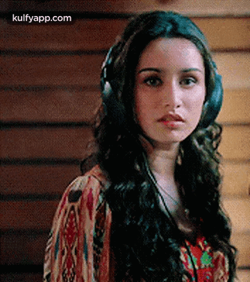 Woman Wearing Headphones Looking at Camera