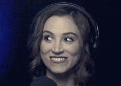 Woman Wearing Headphones Looks at Camera