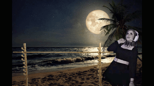 Woman Wearing Headphones on Beach at Night