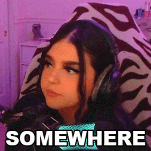 Woman Wearing Headphones Sitting in Chair Saying Somewhere