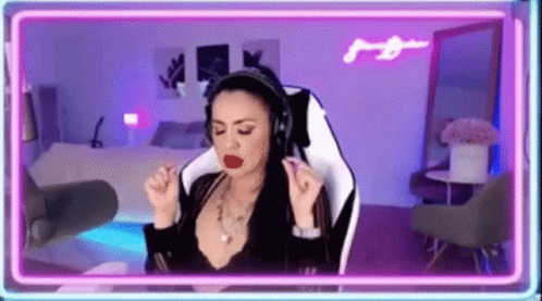 Woman Wearing Headphones Sitting In Front Of Neon Light GIF