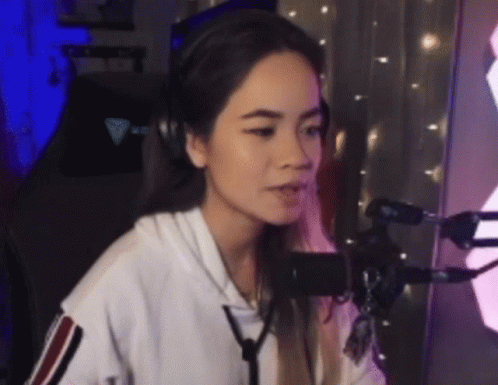 Woman Wearing Headphones Talking Into Microphone