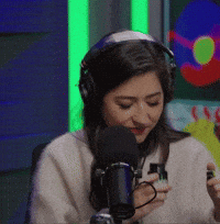 Woman Wearing Headphones Talking Into Microphone