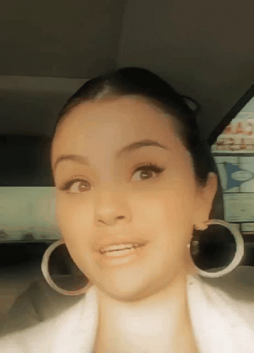 Woman Wearing Hoop Earrings And White Jacket GIF