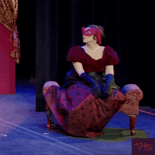 Woman Wearing Mask and Gloves on Stage