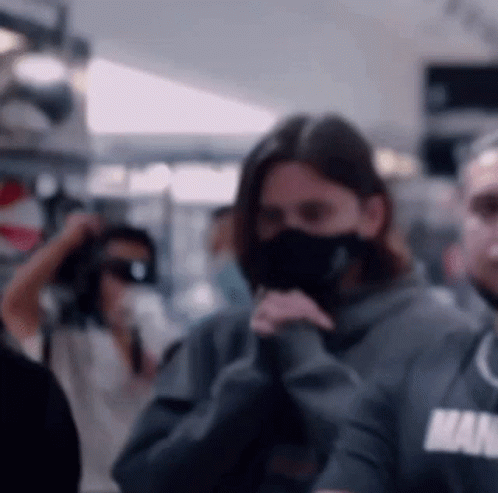 Woman Wearing Mask And Man In Hoodie GIF