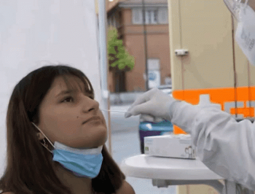 Woman Wearing Mask Getting Swab From Doctor GIF