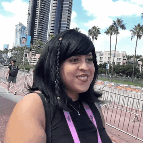 Woman Wearing SDCC Lanyard Smiling GIF