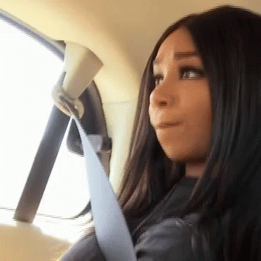 Woman Wearing Seat Belt Looks Out Window GIF