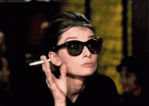Woman Wearing Sunglasses and Smoking