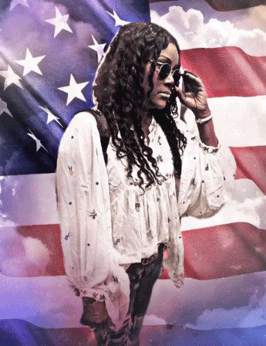 Woman Wearing Sunglasses in Front of American Flag