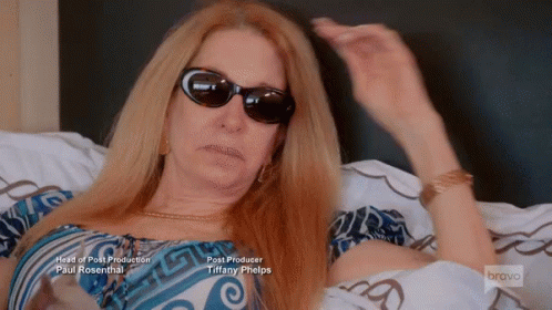 Woman Wearing Sunglasses Lying on Bed