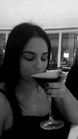Woman Winks And Drink Espresso Cocktail GIF