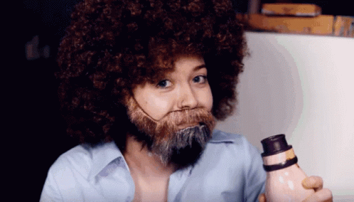 Woman with Afro and Beard Holding Bottle