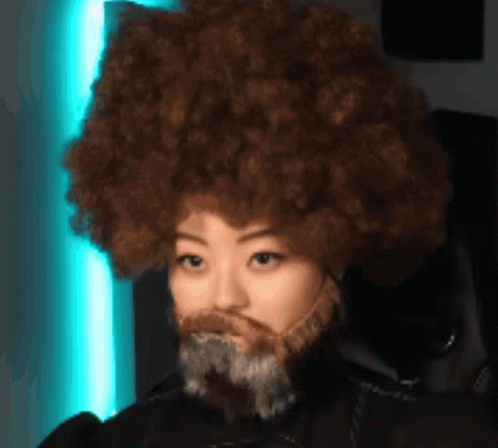 Woman with Afro and Beard Wearing Headphones