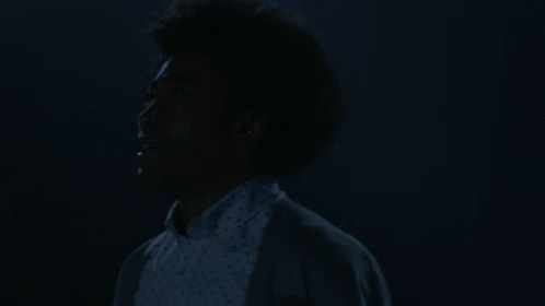 Woman with Afro Eyes Closed in Dark