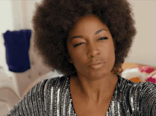 Woman With Afro in Sequined Top Looking at Camera