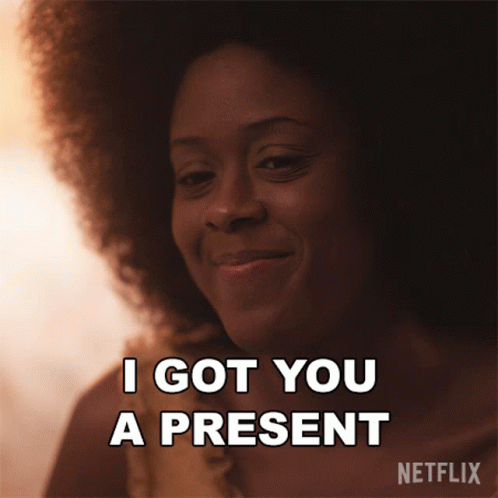 Woman With Afro Smiling Says I Got You a Present