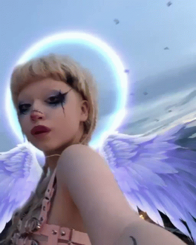 Woman With Angel Wings and Halo Selfie