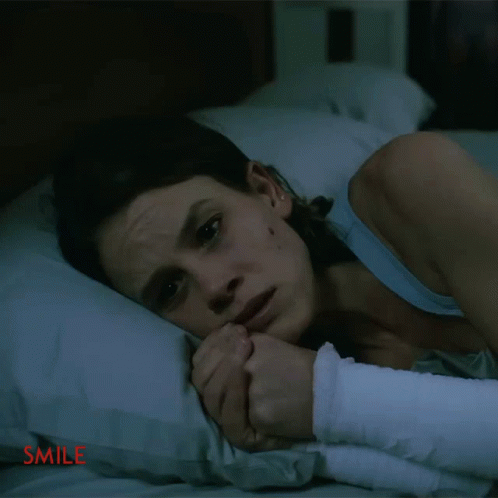 Woman With Arm Bandage Lying on Bed Smile