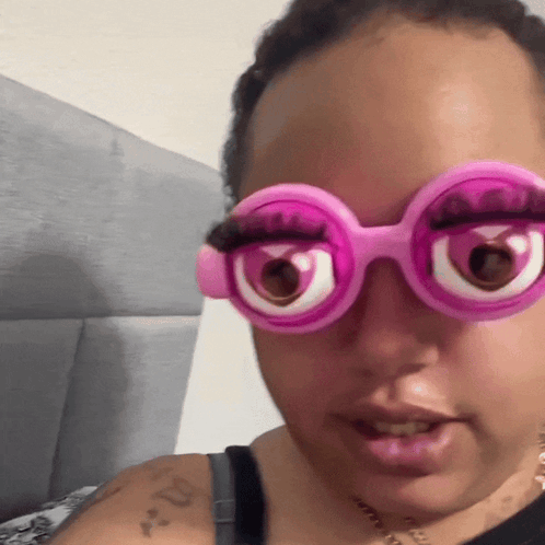 Woman With Arm Tattoo And Pink Glasses GIF